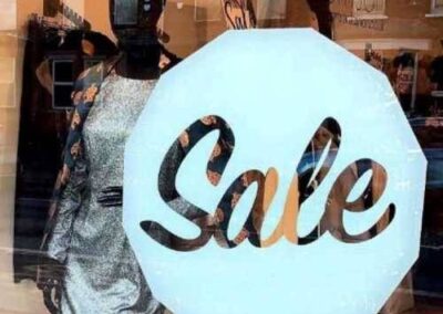 Sale shop window sticker in the shape of a coin - bold and clear, shown here in white (choose colour to suit)