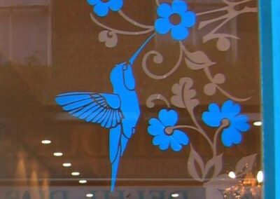 Ornate framing to a shop window display using Oriental Fauna Border Kit