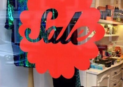 Doily style sale shop window sticker shown here in red (over 30 colours to choose from)